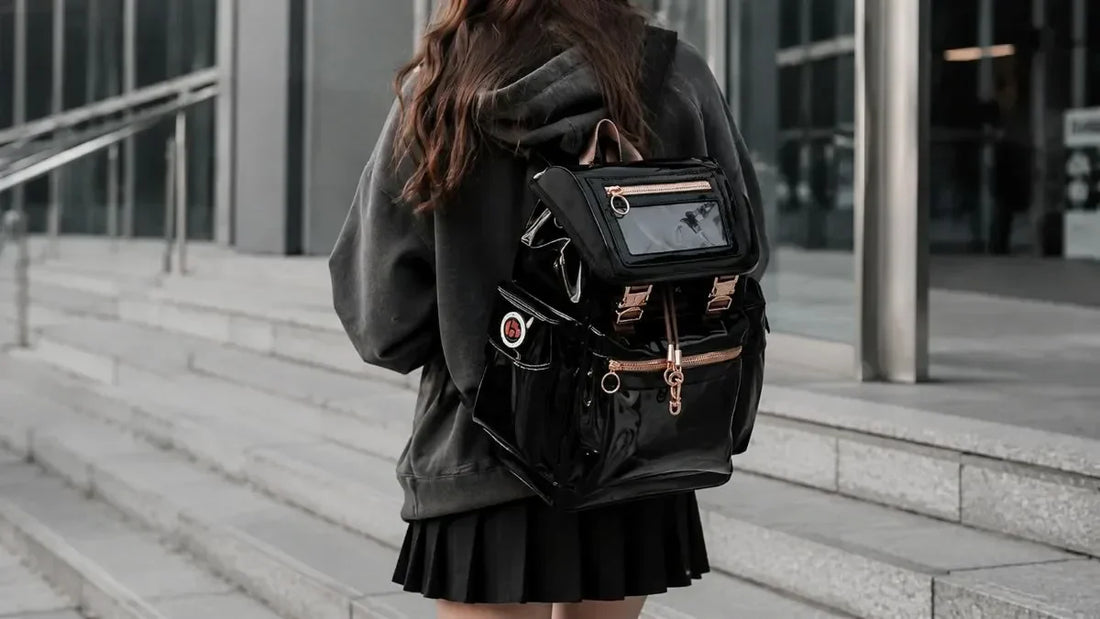Black ita bag with a clear vinyl display window on the front pocket, shown against a neutral background.