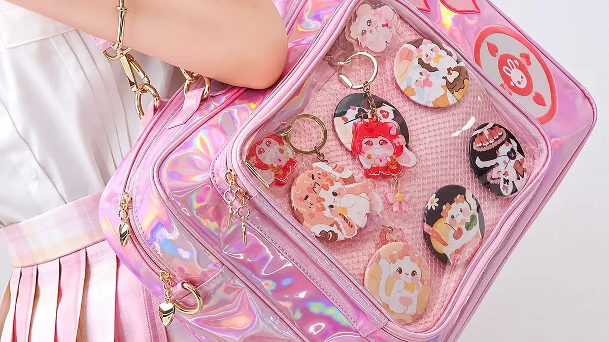 itabag-shop holographic pink ita bag featuring cute enamel pins, anime keychains, and collectible badges.