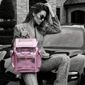 Woman holding a frozen berry metallic Cyberpunk Ita Backpack in front of a Porsche Taycan.