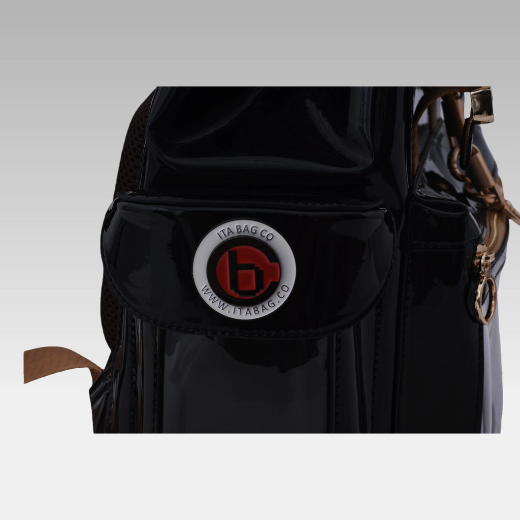 Close-up macro detail of the custom hardware emblem on the Glossy Black Cyberpunk Ita Bag Mini.