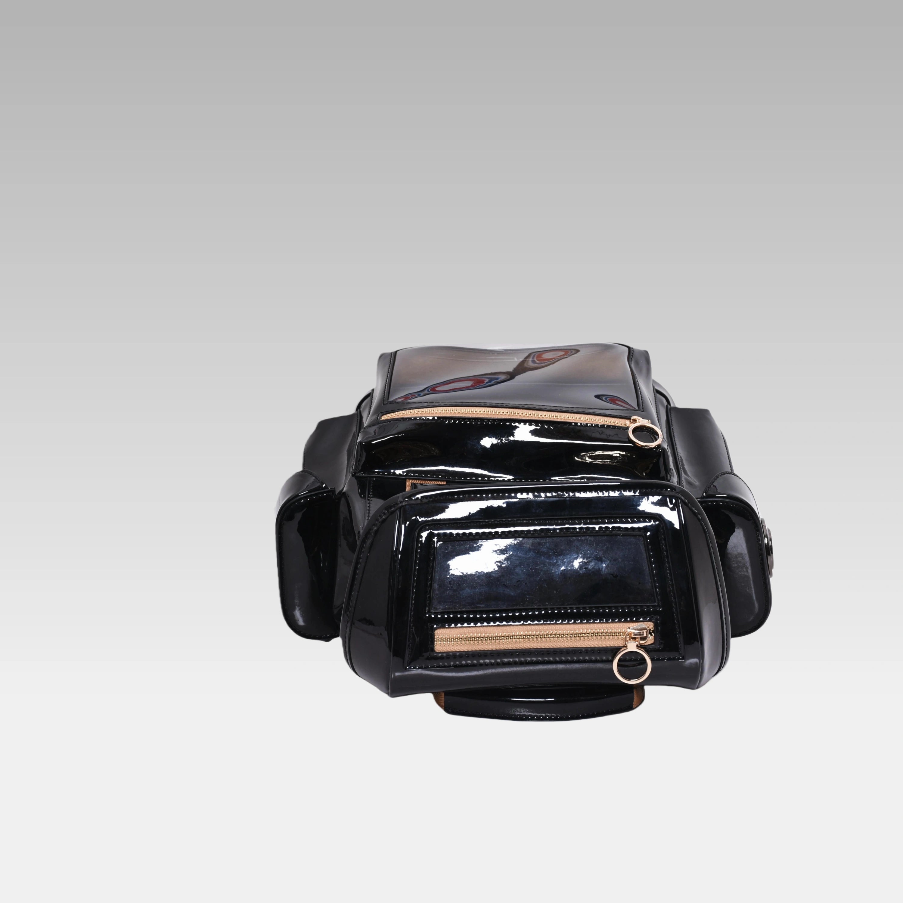 Top-down view of the Glossy Black Cyberpunk Ita Backpack Mini highlighting the grab handle and top zipper closures.
