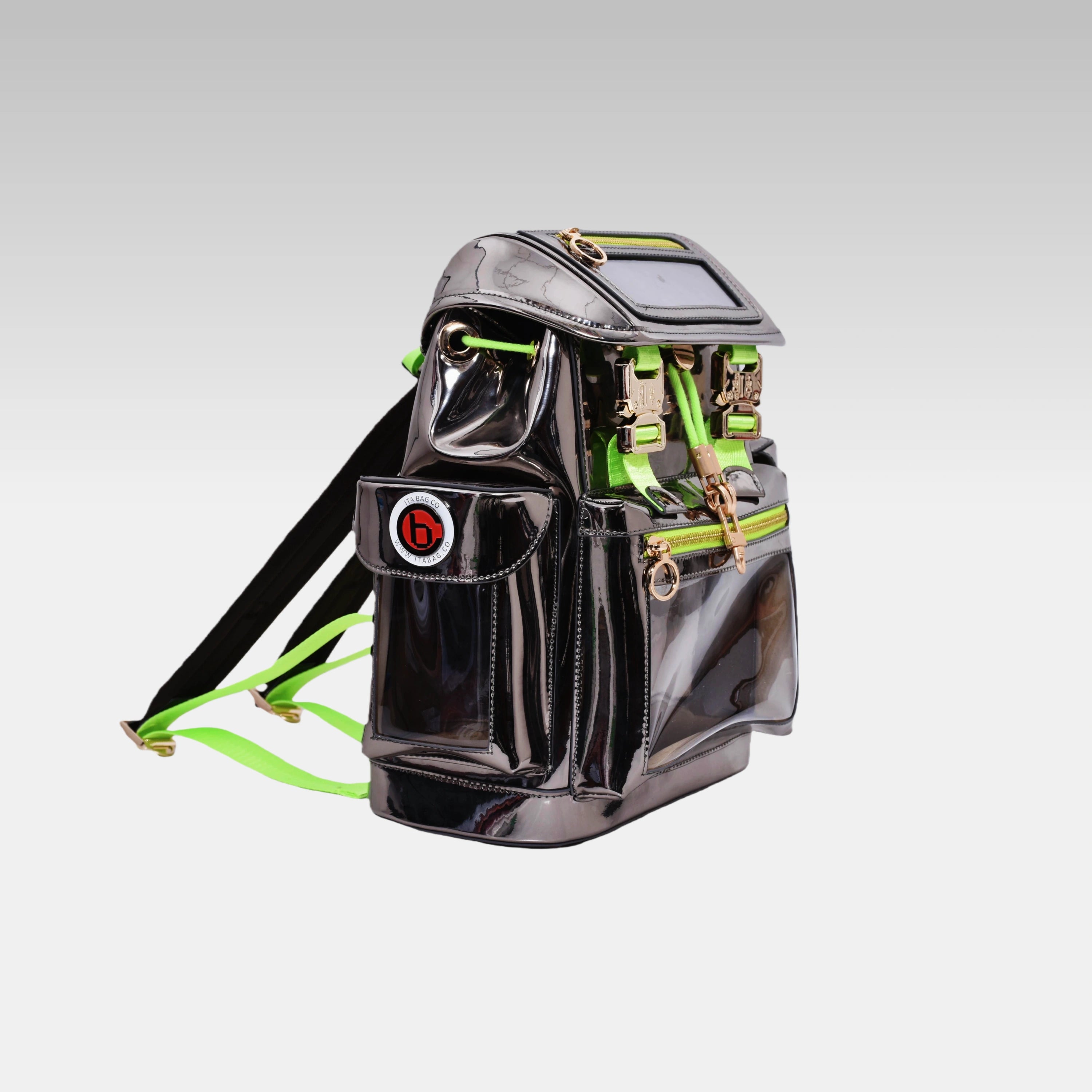 Side profile of the Metallic Gray Cyberpunk Ita Backpack Mini featuring the prominent custom hardware emblem.
