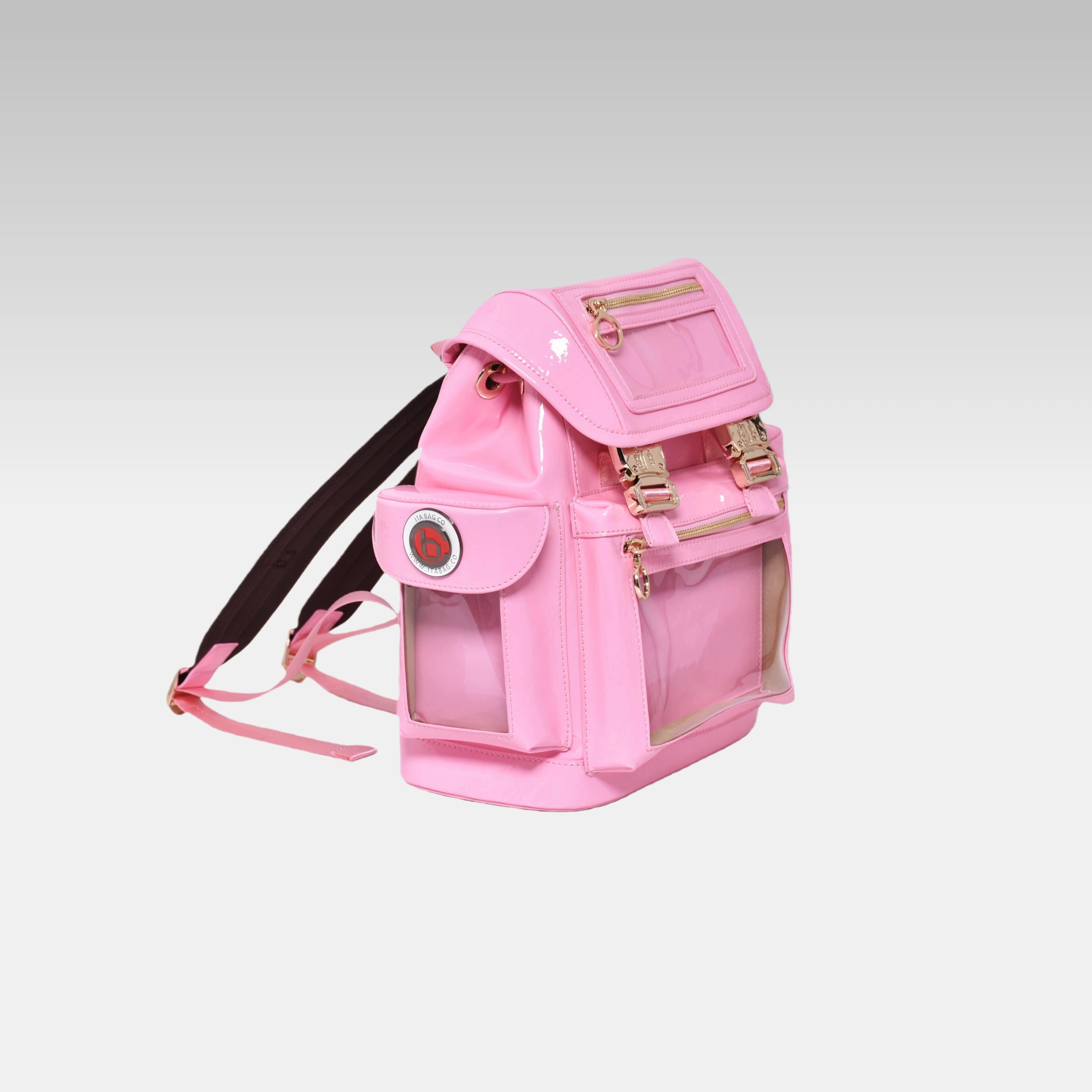 Side profile of the Pastel Pink Cyberpunk Ita Backpack Mini featuring the prominent custom hardware emblem.
