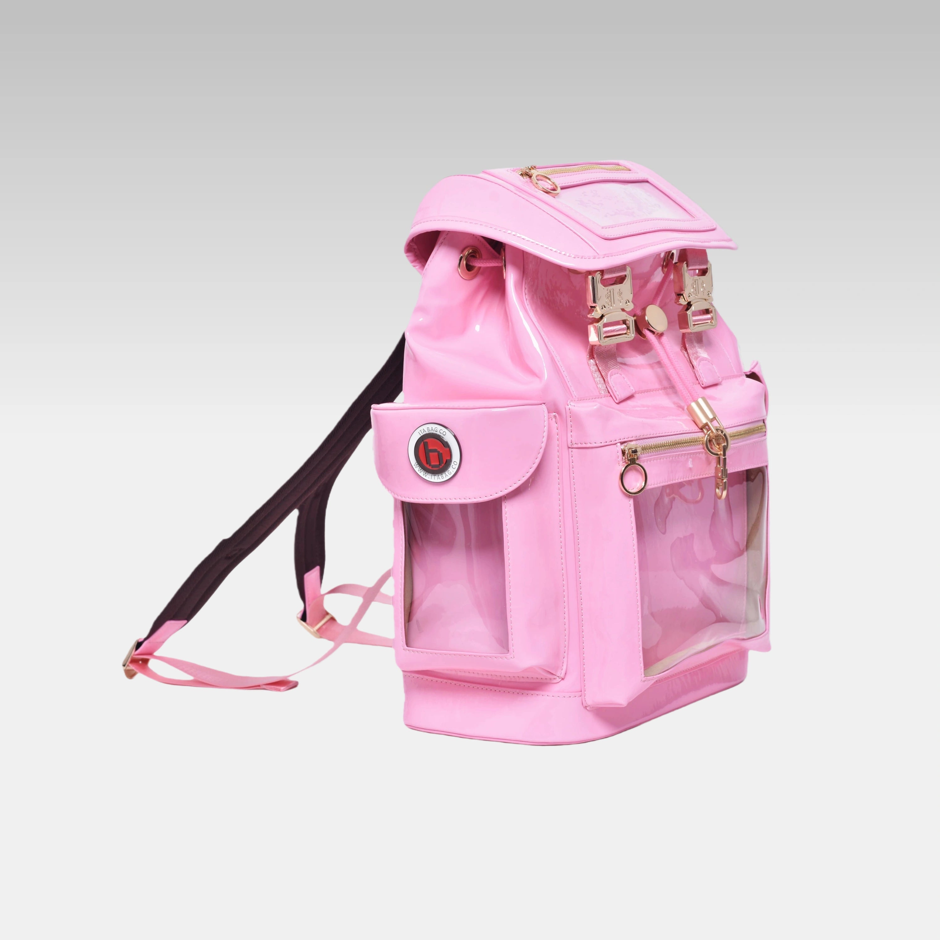 Side profile of the Pastel Pink Cyberpunk Ita Backpack featuring the prominent custom hardware emblem.
