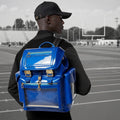 Model wearing the standard Quantum Blue Cyberpunk Ita Backpack, a high quality ita bag acting as a durable clear window backpack for serious collectors.